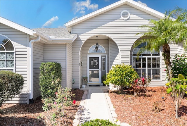 property entrance with roof with shingles