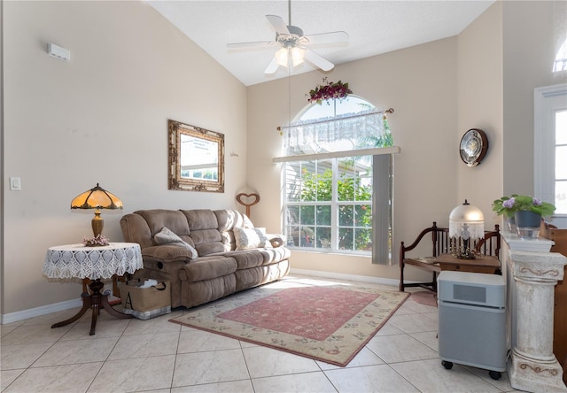 living area with light tile patterned floors, baseboards, high vaulted ceiling, and ceiling fan