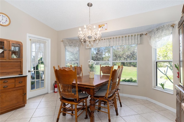 dining area with baseboards, an inviting chandelier, vaulted ceiling, a textured ceiling, and light tile patterned flooring