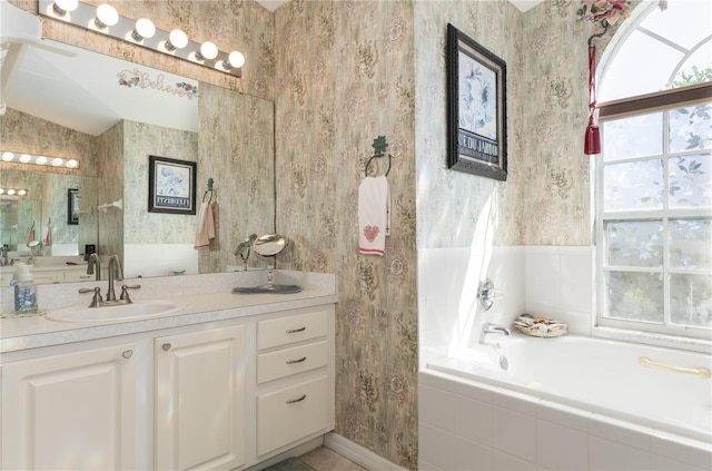 bathroom with a bath, vanity, a wealth of natural light, and wallpapered walls