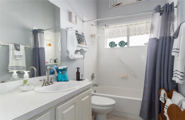 bathroom featuring tile patterned flooring, shower / bath combo, vanity, and toilet