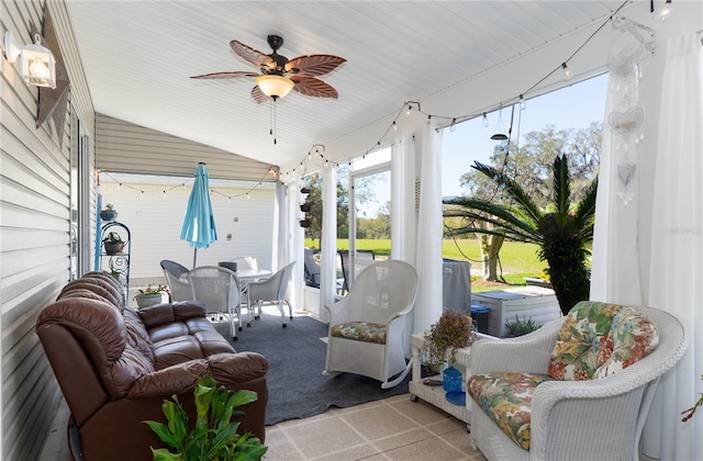 sunroom featuring vaulted ceiling and a ceiling fan