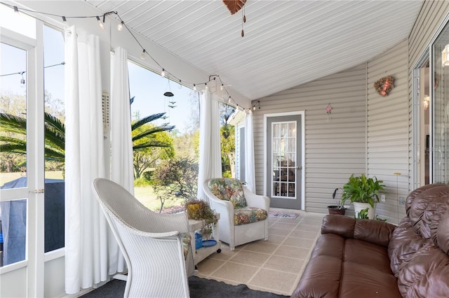 sunroom featuring lofted ceiling