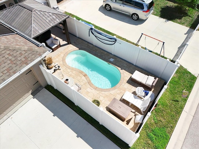 exterior space featuring a patio area, a fenced backyard, and a fenced in pool