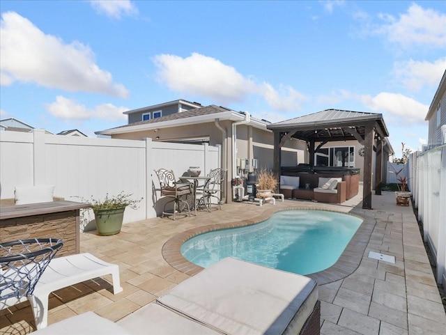 view of swimming pool featuring a gazebo, a patio area, a fenced backyard, and a hot tub