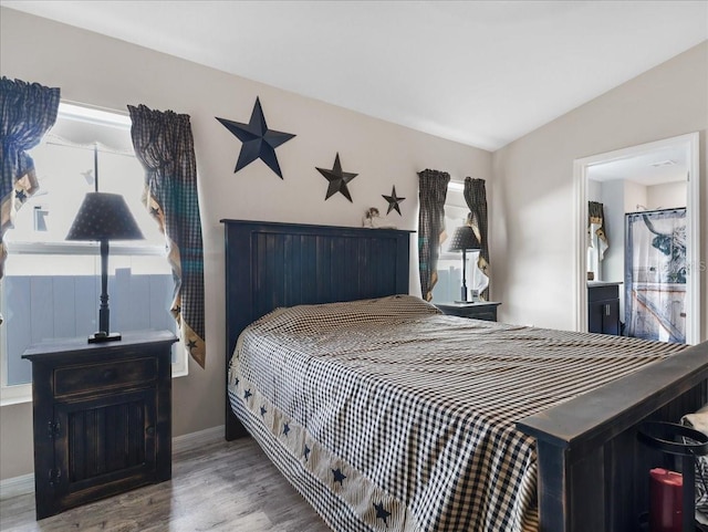 bedroom with baseboards and wood finished floors