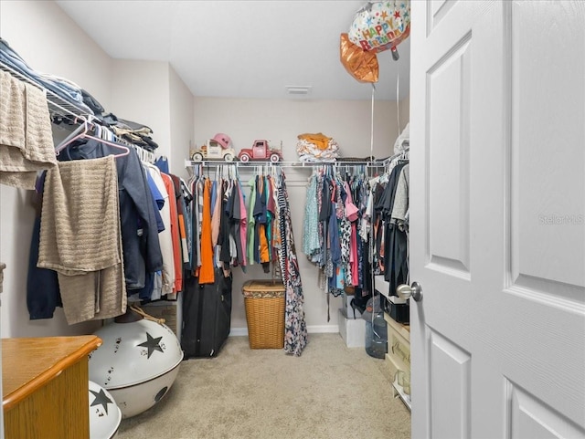 spacious closet featuring carpet flooring