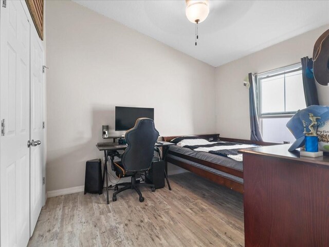 bedroom featuring wood finished floors and baseboards