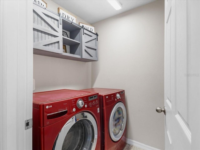 laundry area featuring laundry area, independent washer and dryer, and baseboards