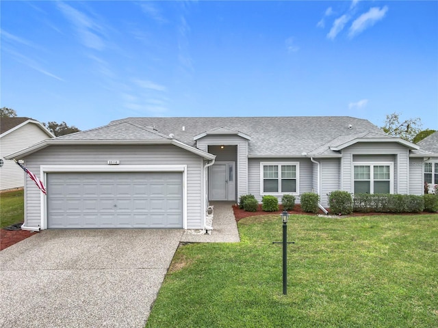 view of front facade featuring driveway, a shingled roof, an attached garage, and a front yard