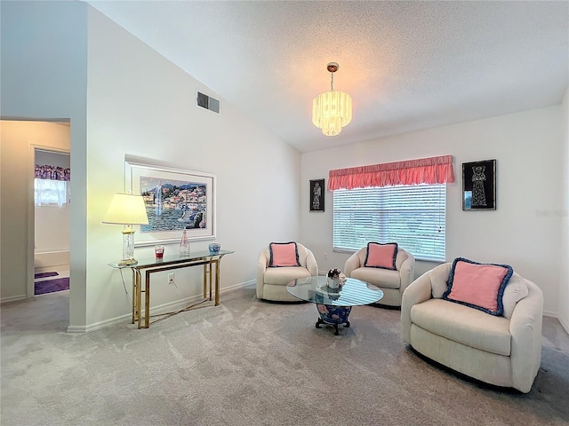 living area with lofted ceiling, a textured ceiling, a chandelier, carpet flooring, and visible vents