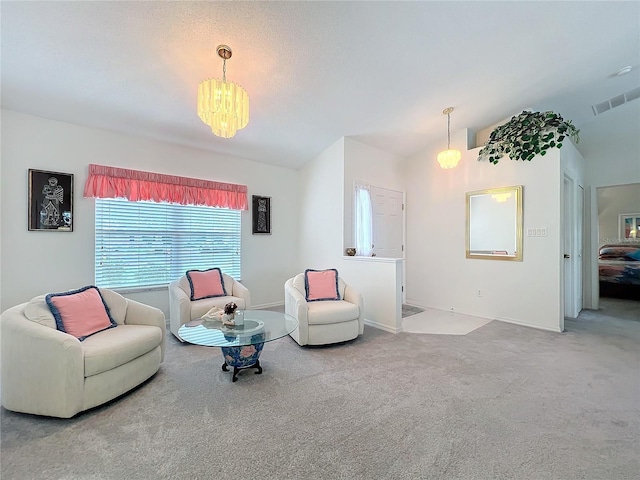 living room with carpet flooring, vaulted ceiling, visible vents, and an inviting chandelier