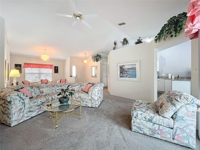 carpeted living area featuring a ceiling fan, visible vents, and vaulted ceiling