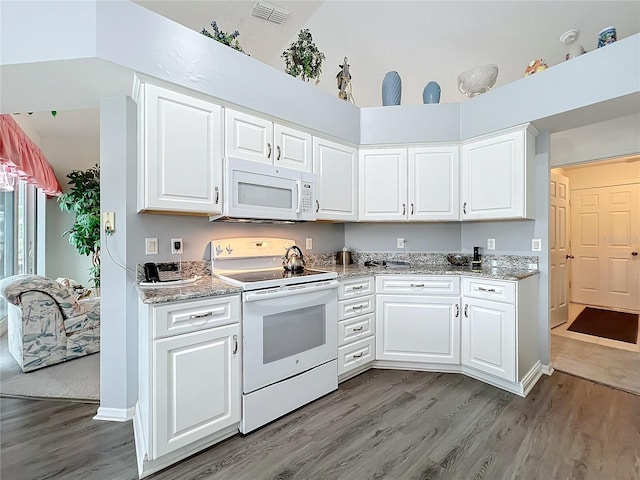 kitchen with light wood-type flooring, white appliances, visible vents, and white cabinetry