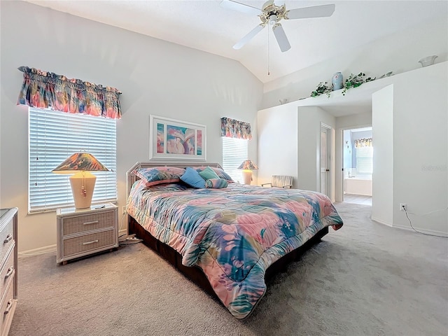 bedroom featuring light carpet, vaulted ceiling, ensuite bath, and baseboards