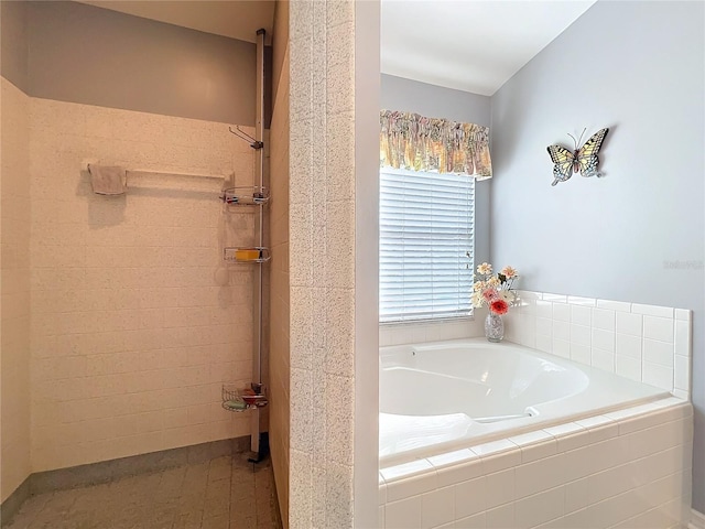 bathroom with a tile shower and a bath