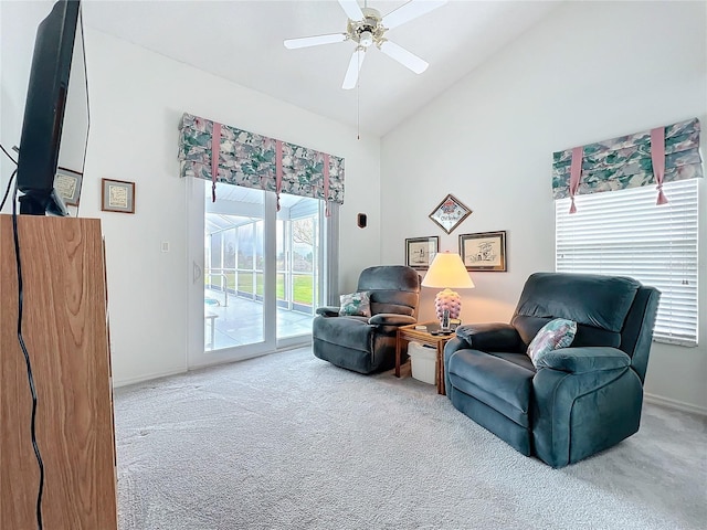 living area featuring baseboards, a sunroom, ceiling fan, carpet, and high vaulted ceiling