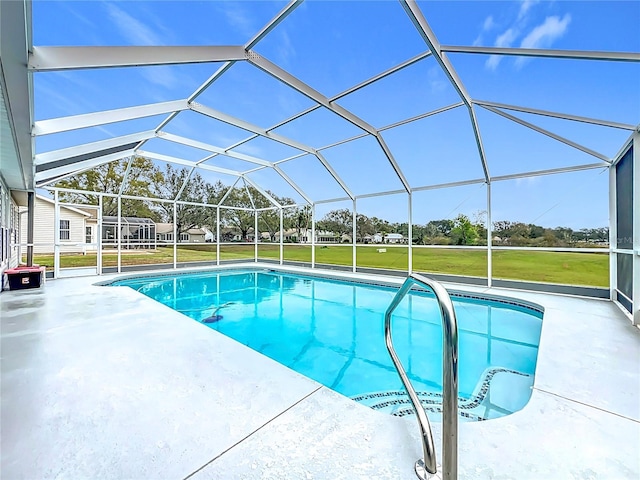 pool with a lawn, a patio area, and a lanai