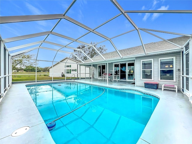 outdoor pool with a patio and glass enclosure