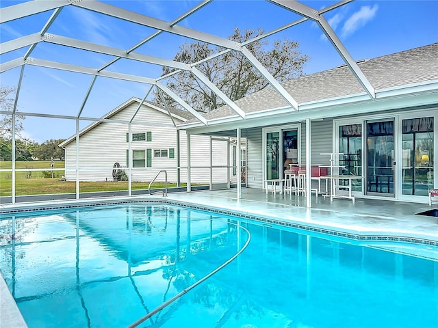 pool with a patio area and glass enclosure