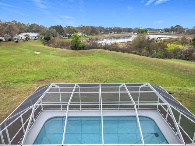 pool with a lanai and a lawn