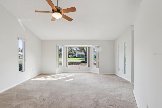 interior space featuring vaulted ceiling, ceiling fan, carpet flooring, and baseboards