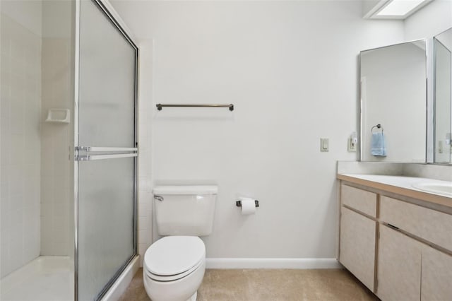 full bath featuring vanity, a shower stall, toilet, and baseboards