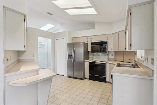 kitchen with electric range, light countertops, black microwave, stainless steel refrigerator with ice dispenser, and a sink