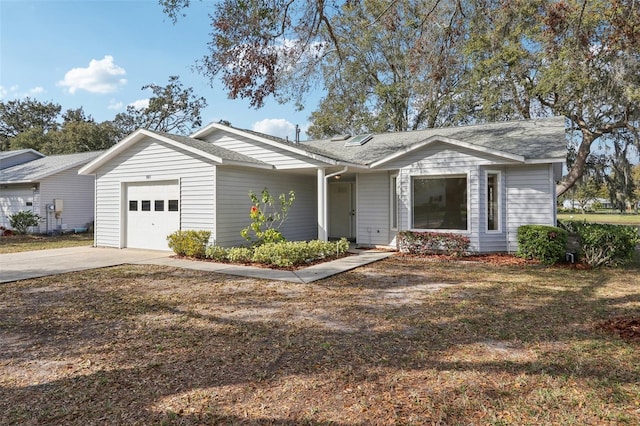 ranch-style house featuring concrete driveway and an attached garage