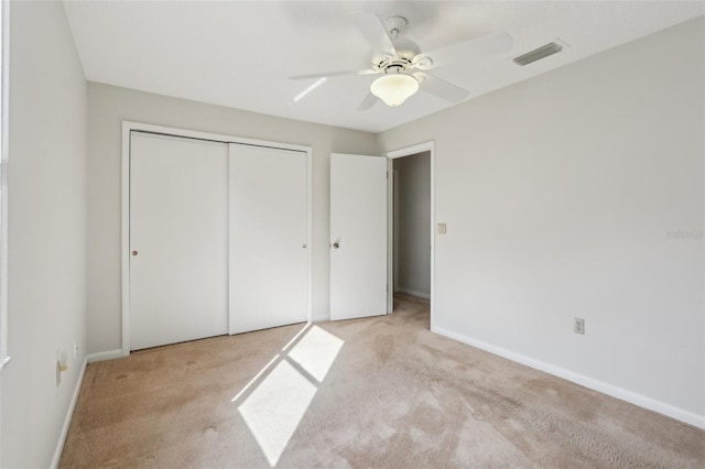 unfurnished bedroom featuring a closet, baseboards, visible vents, and carpet flooring