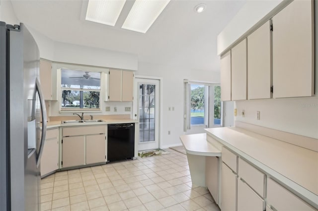 kitchen with light tile patterned floors, black dishwasher, stainless steel fridge with ice dispenser, light countertops, and a sink