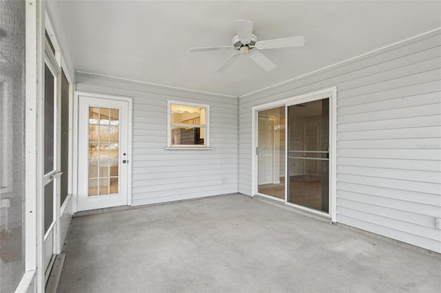 unfurnished sunroom with a ceiling fan