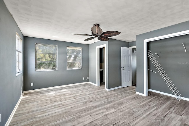 1301 N Shore Dr, Leesburg, FL 34748 - unfurnished bedroom featuring a closet, baseboards, and wood finished floors