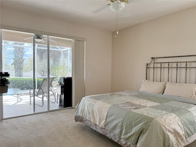 carpeted bedroom with access to outside, ceiling fan, and a textured ceiling