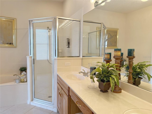 full bathroom with a garden tub, double vanity, a stall shower, a sink, and tile patterned flooring