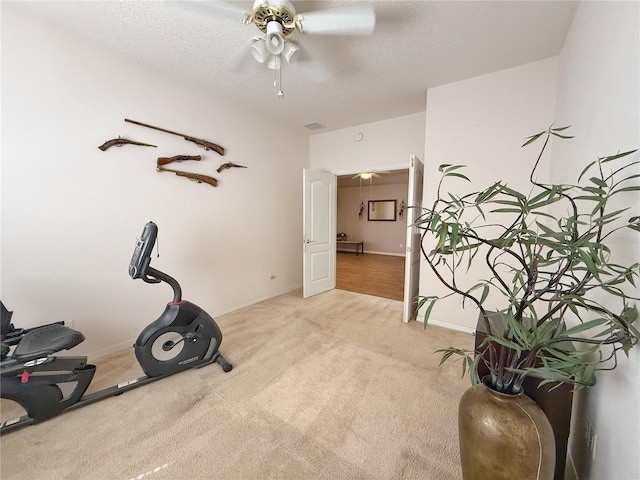 workout area with visible vents, light carpet, ceiling fan, a textured ceiling, and baseboards