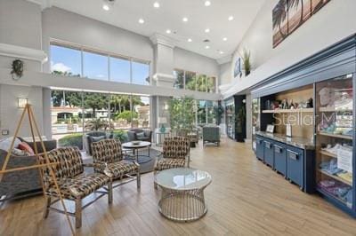 interior space featuring light wood-type flooring, a high ceiling, and recessed lighting