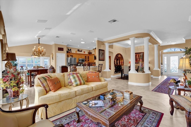 living room featuring a wealth of natural light, visible vents, and ornate columns