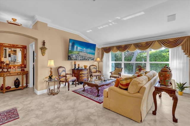 living room featuring lofted ceiling, ornamental molding, arched walkways, and baseboards