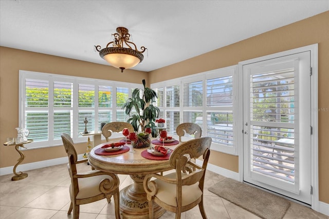 dining room featuring baseboards and light tile patterned floors