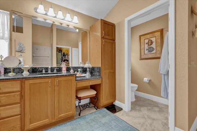 full bath featuring toilet, tile patterned flooring, vanity, and baseboards