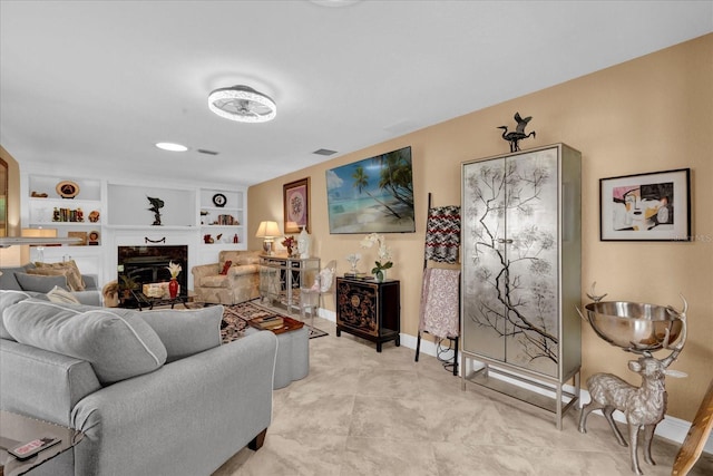 living room with baseboards, a fireplace, visible vents, and built in features