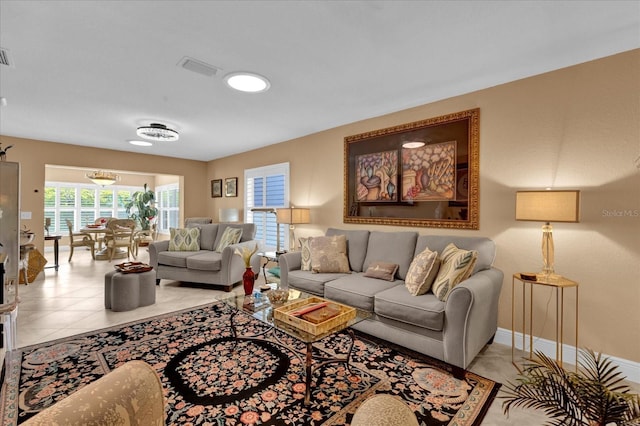 living room featuring visible vents, baseboards, and light tile patterned floors