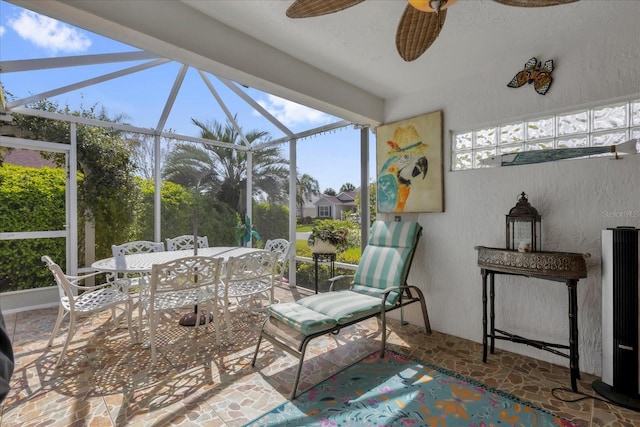 sunroom featuring ceiling fan