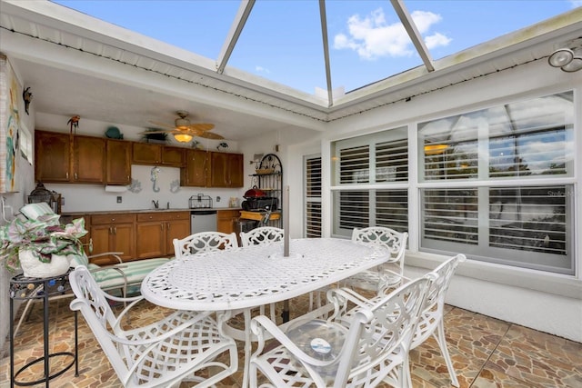 exterior space featuring a lanai, outdoor dining area, and a ceiling fan