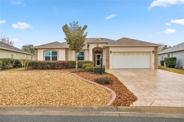 view of front of home featuring driveway, a shingled roof, a garage, and stucco siding