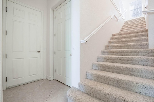 staircase with tile patterned flooring