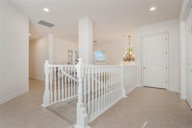 hall featuring baseboards, an inviting chandelier, an upstairs landing, and recessed lighting