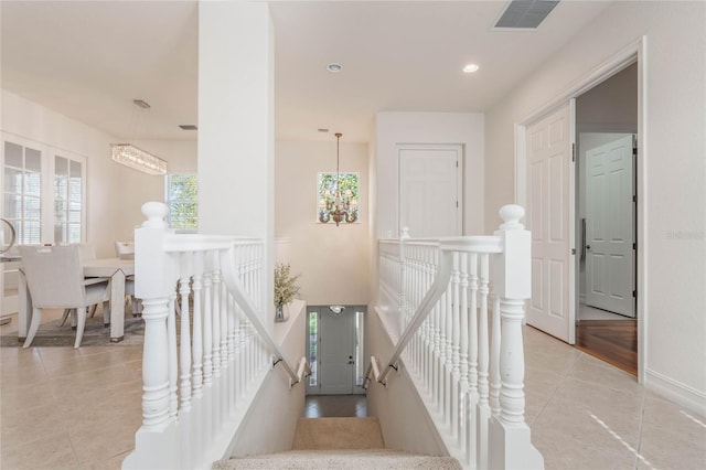 stairs with tile patterned flooring, visible vents, and recessed lighting