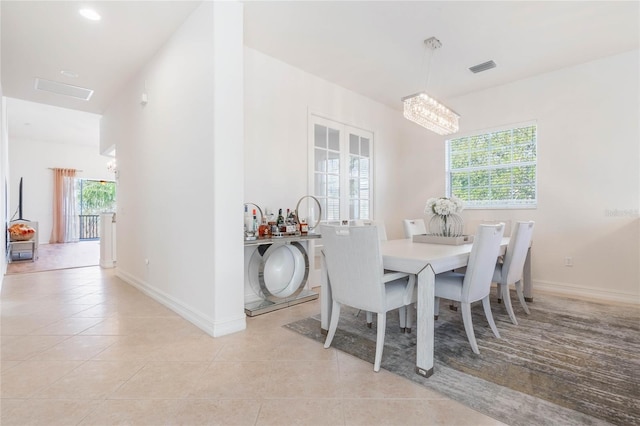 dining space featuring light tile patterned flooring, visible vents, and baseboards